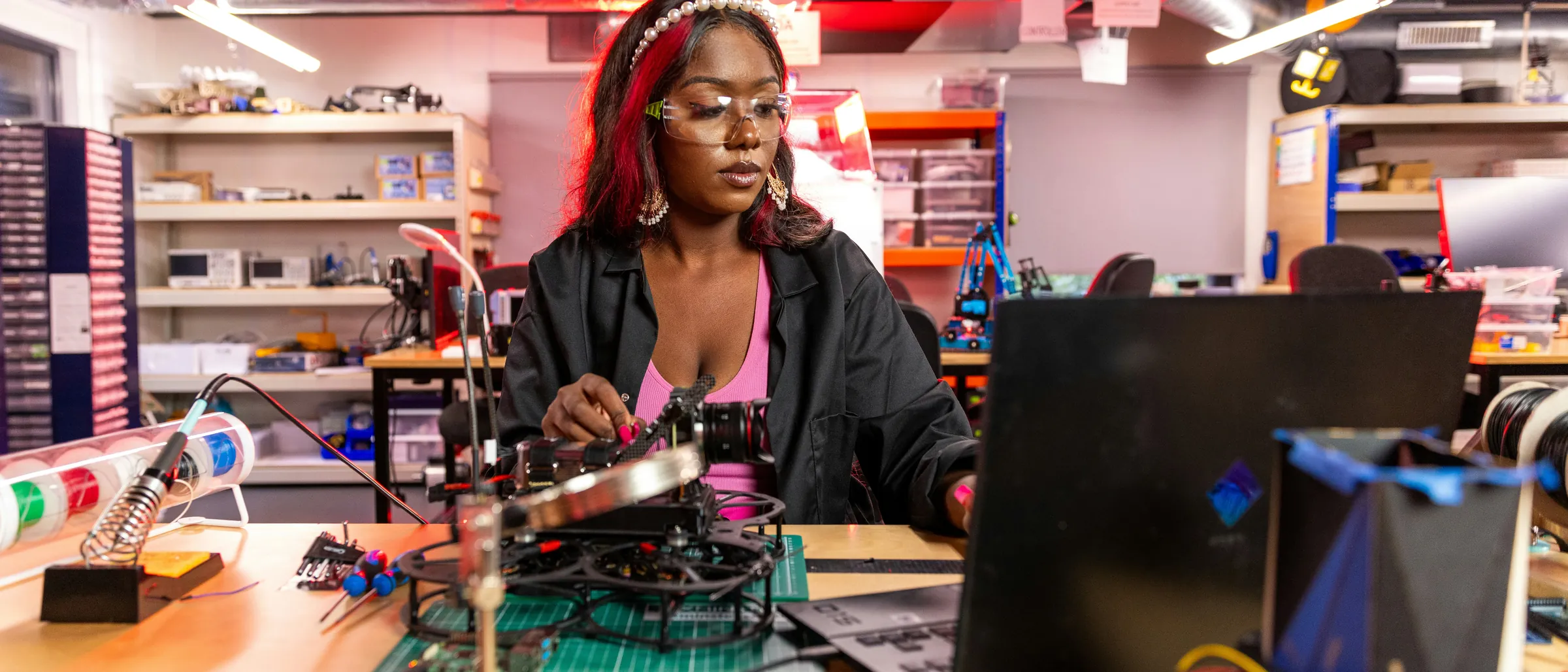 An engineer building electronics at a workbench
